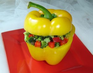 Stuffed Yellow pepper with Broccoli Salad with Capers on a red ceramic plate - broccoli nutrition - broccoli health benefits