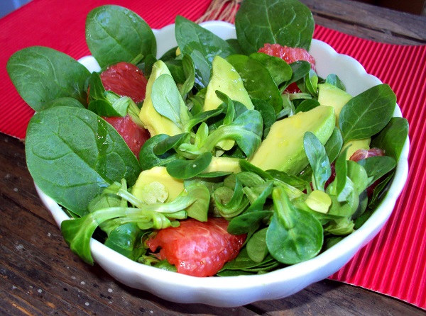 Spinach with Pink Grapefruit in a white bowl